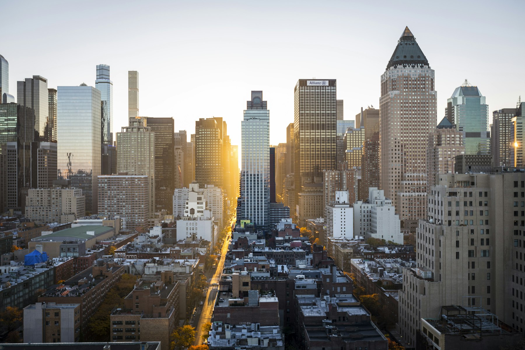 Elevated city skyline with sunlight between the buildings